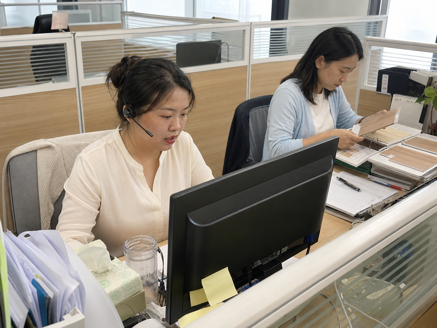 Customer service team working at their desks and reviewing finish samples